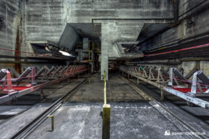 Conveyors below the rial-unloader hoppers